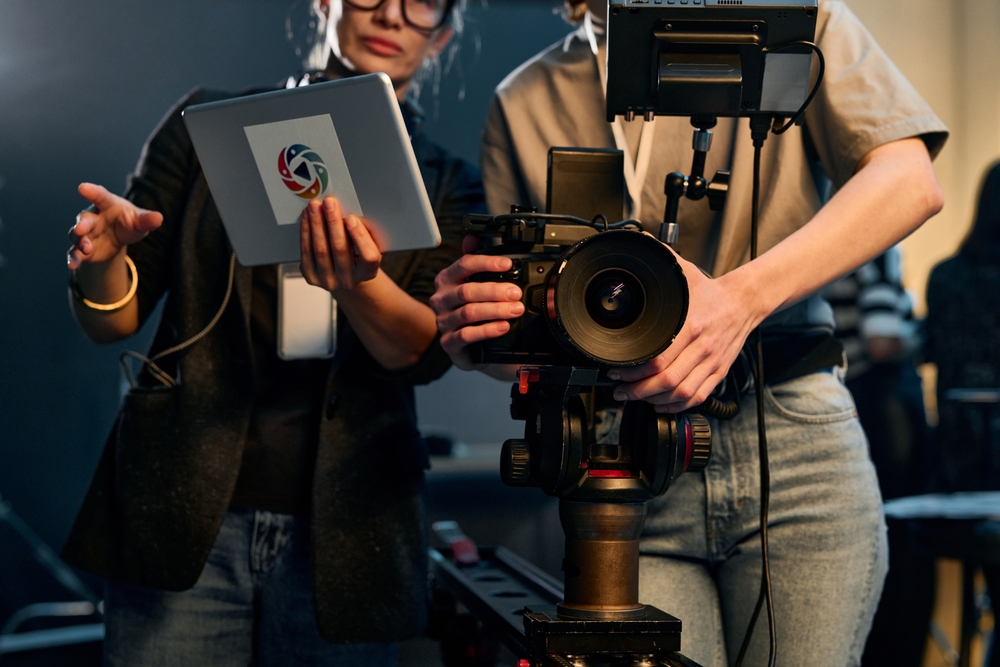 Font,View,Cropped,Shot,Of,Two,Women,Operating,Pro,Video movie set film camera