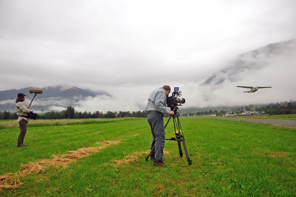Tv,Director,At,Editor,In,Studio.,Tv,Director,Talking,To film crew filming a plane taking off