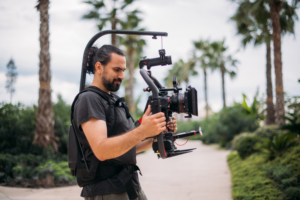 Director,At,Work,On,The,Set.,The,Director,Works,With Director Of Photography With A Camera In His Hands On Location