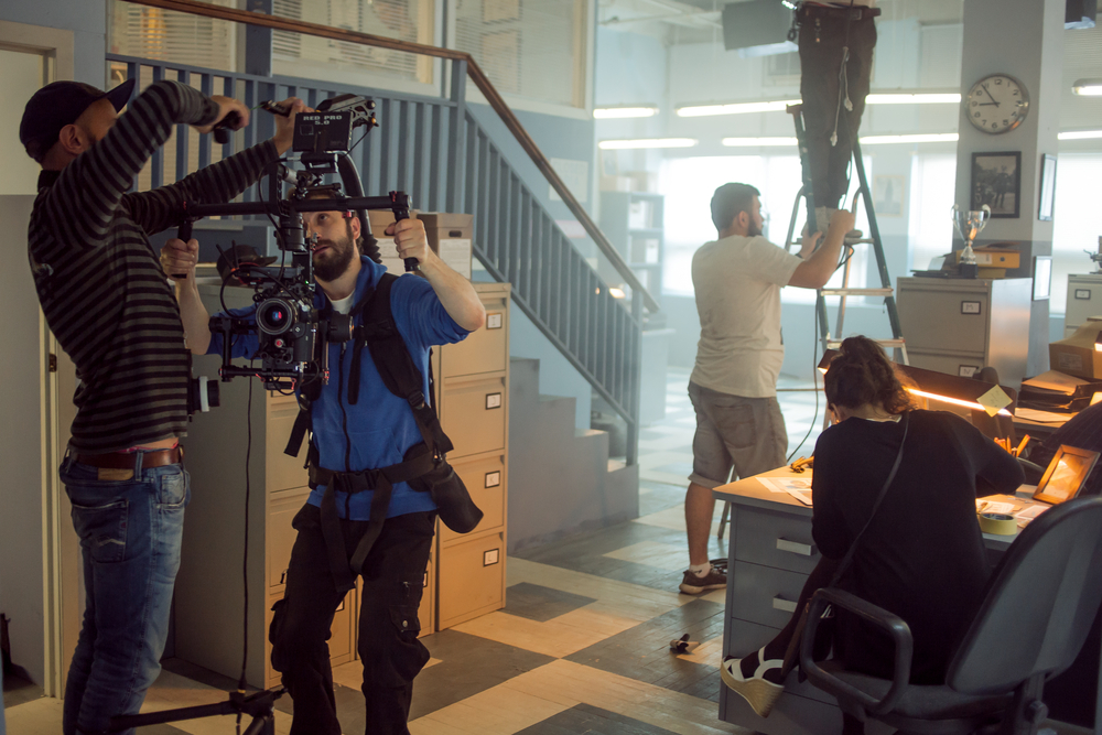 Tv,Director,At,Editor,In,Studio.,Tv,Director,Talking,To local video crew filming on location
